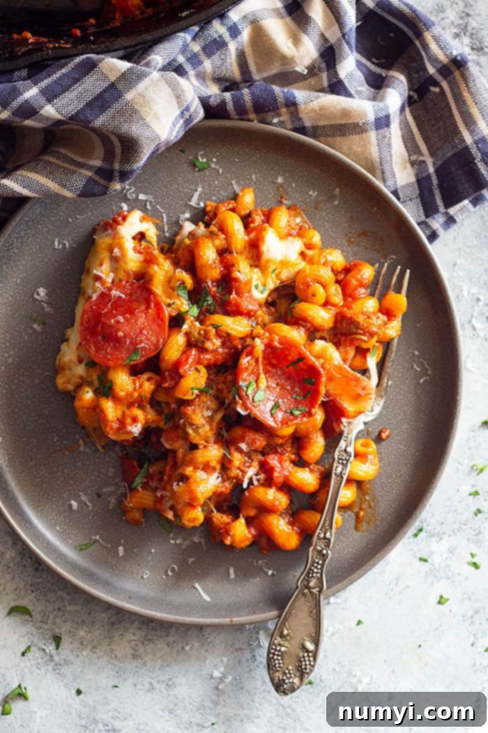 This One Pot Pizza Pasta is a quick and easy dinner recipe for any night of the week! Use whatever pizza ingredients you like or have on hand! #pastarecipes #pizzapasta