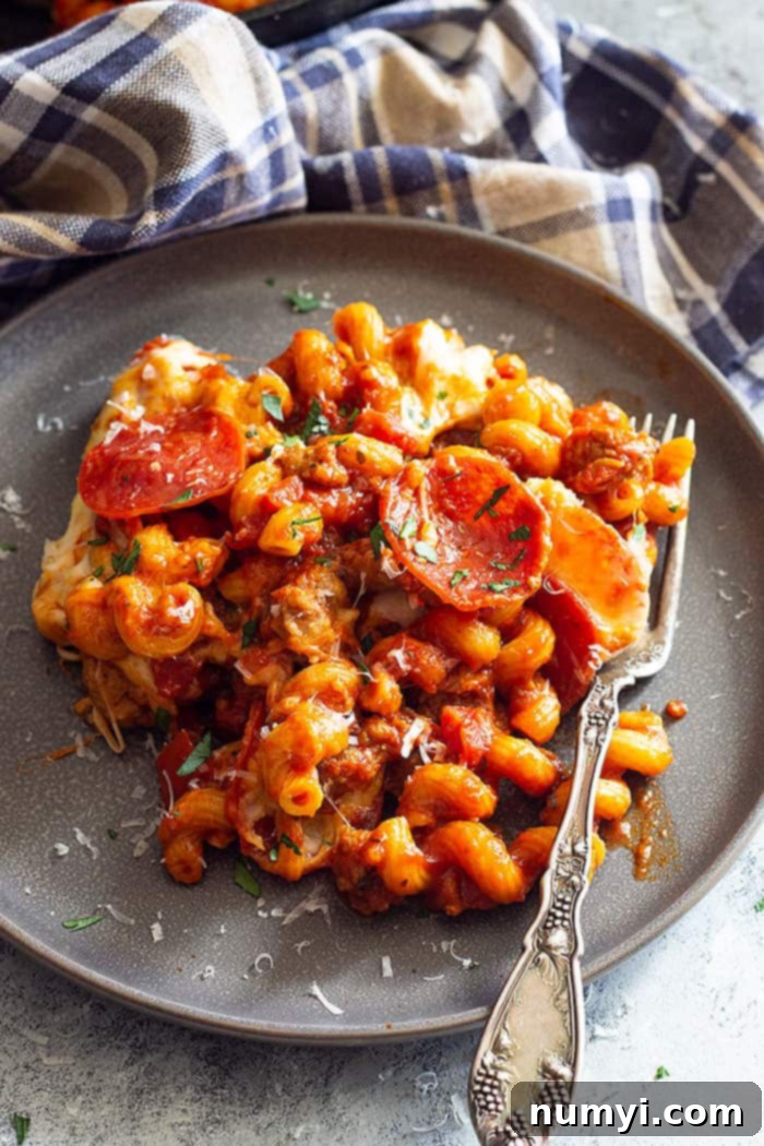 This One Pot Pizza Pasta is a great weeknight meal. It's fast, easy, and full of flavor! Plus, use whatever pizza toppings that are your favorite!! #pastarecipe #onepot