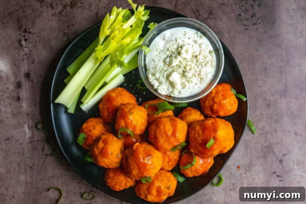 Buffalo chicken meatballs with garnish.