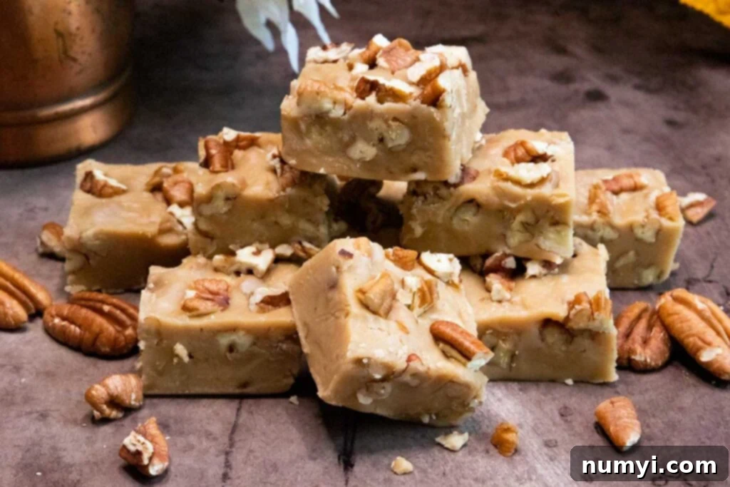 Freshly made butter pecan fudge cooling on a sheet pan, ready to be cut.
