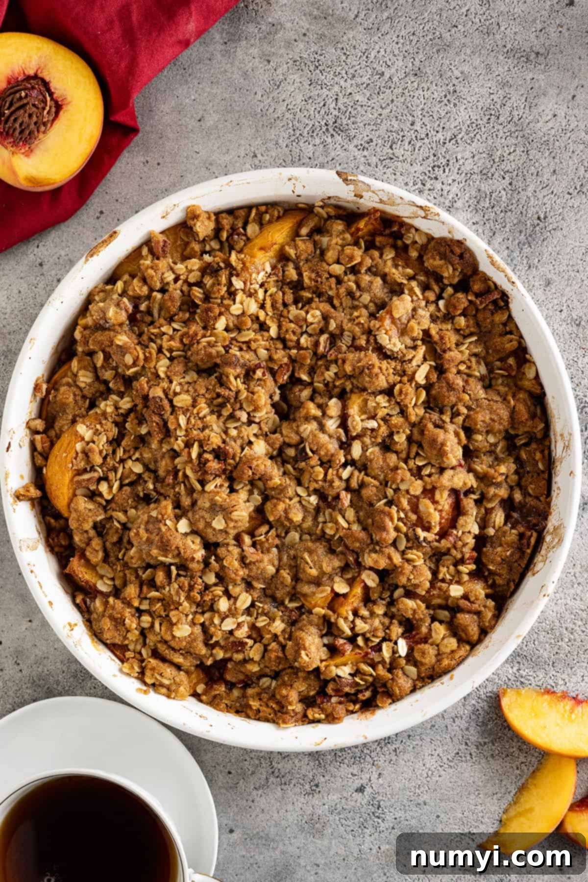 Overhead view of a freshly baked peach crisp, golden brown and bubbling, straight out of the oven.