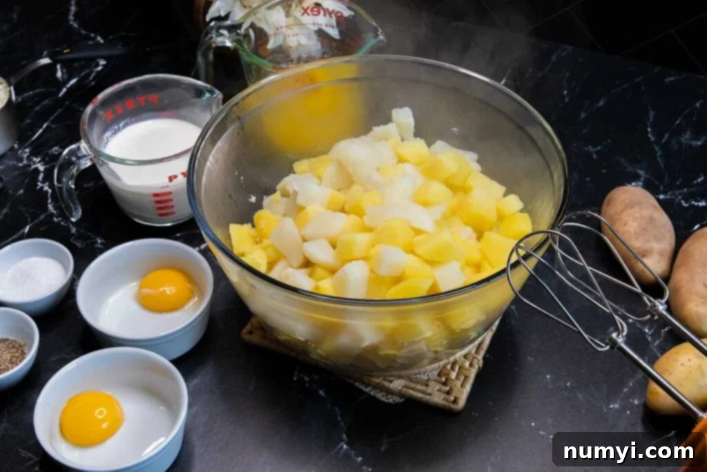 Boiled potatoes with butter, cream, and egg yolks laid out.