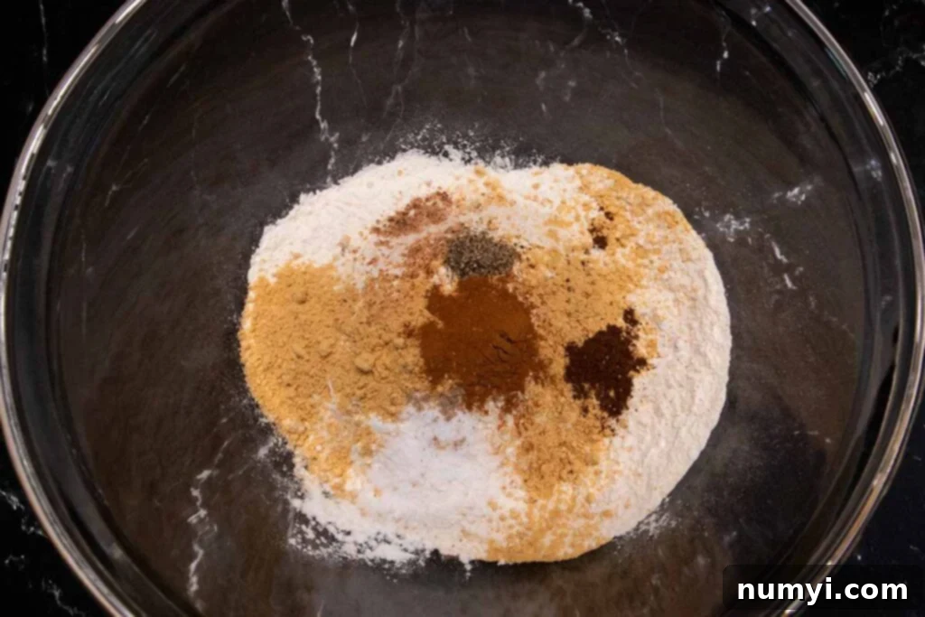Spices and flour in a glass mixing bowl.