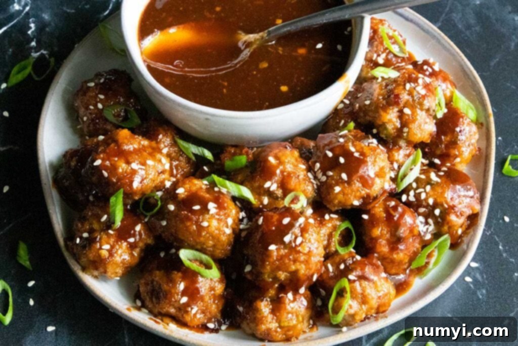 sweet and spicy meatballs on a plate with dipping sauce