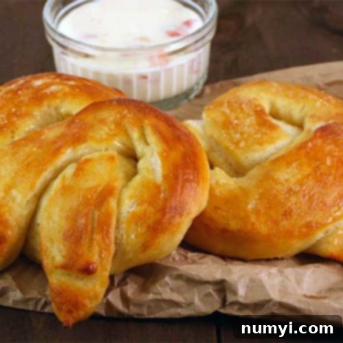 Golden brown soft pretzels on a white background with a clean border.