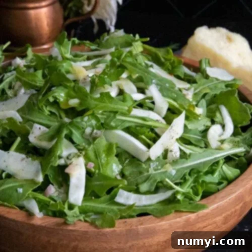Bright Arugula Fennel Salad 7 Arugula fennel salad in a wooden bowl.