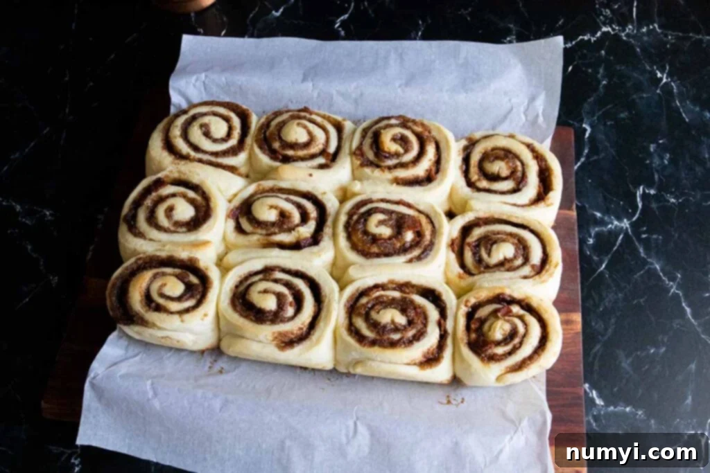 Freshly baked Maple Bacon Cinnamon Rolls, golden brown and glistening, without icing.