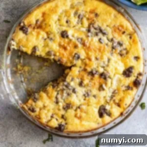 Overhead view of cheeseburger pie with a slice taken out.