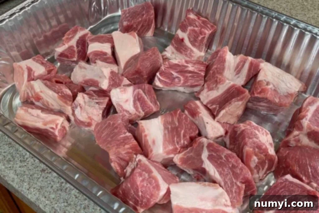 Ultimate Pork Butt Burnt Ends 6 Close-up of raw pork butt cubes, perfectly cut and ready for seasoning, highlighting their consistent size and lean appearance.