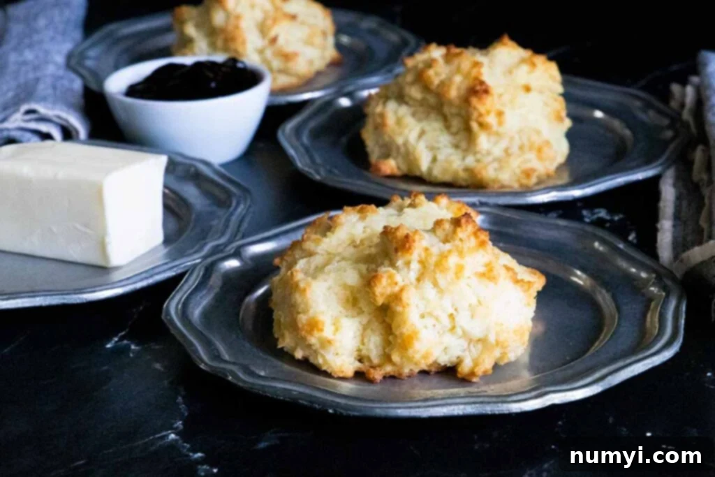 Buttermilk drop biscuits on silver plates.