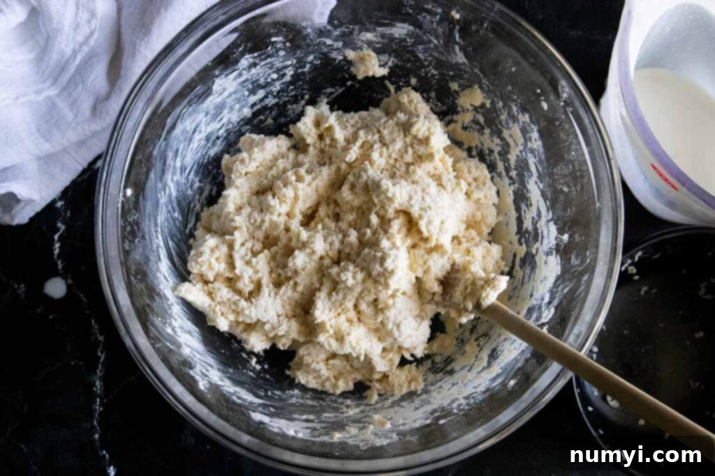 Biscuit dough in glass mixing bowl.