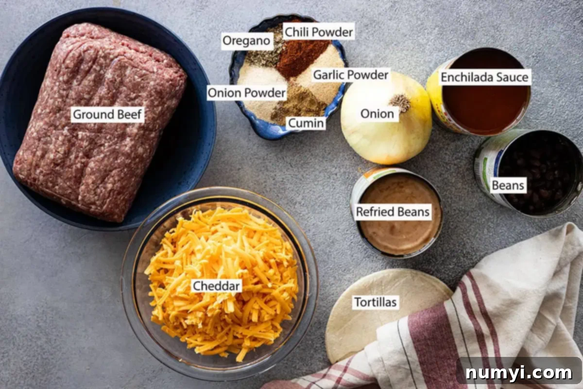 Ingredients: ground beef, beans, refried beans, oregano, cumin, chili powder, garlic powder, onion powder, onion, enchilada sauce, tortillas, and cheese. 