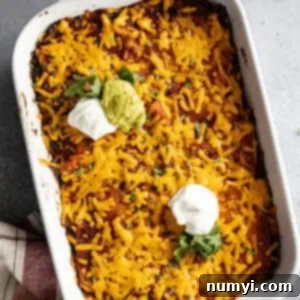 Overhead photo of casserole from the oven and garnished with sour cream, guacamole, and cilantro.
