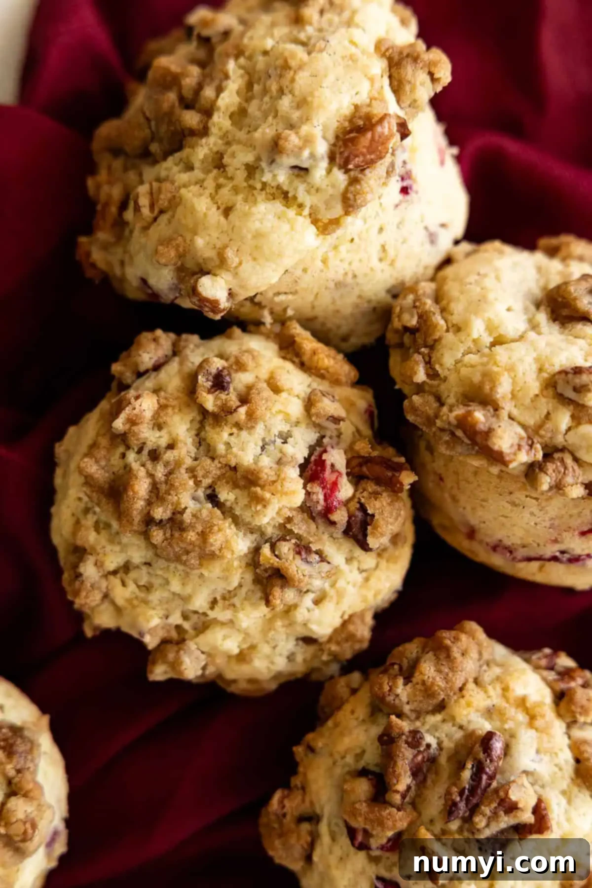 Overhead view of several muffins together on a red napkin. 