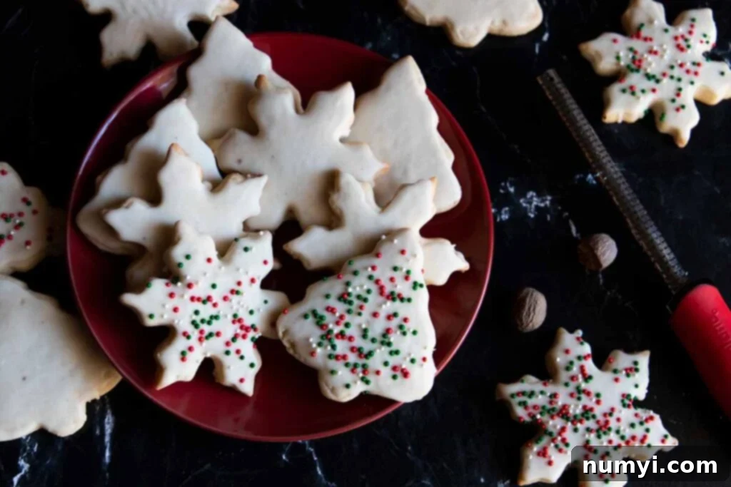 Festive eggnog cookies on a vibrant red plate, garnished with a sprinkle of fresh nutmeg.