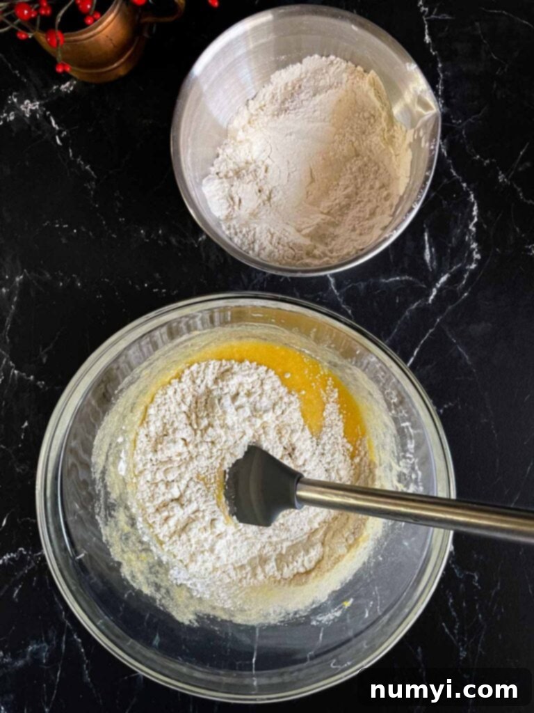 Exquisite White Chocolate Cranberry Pistachio Biscotti 6 Dry ingredients being added to the wet ingredients for cranberry pistachio biscotti.