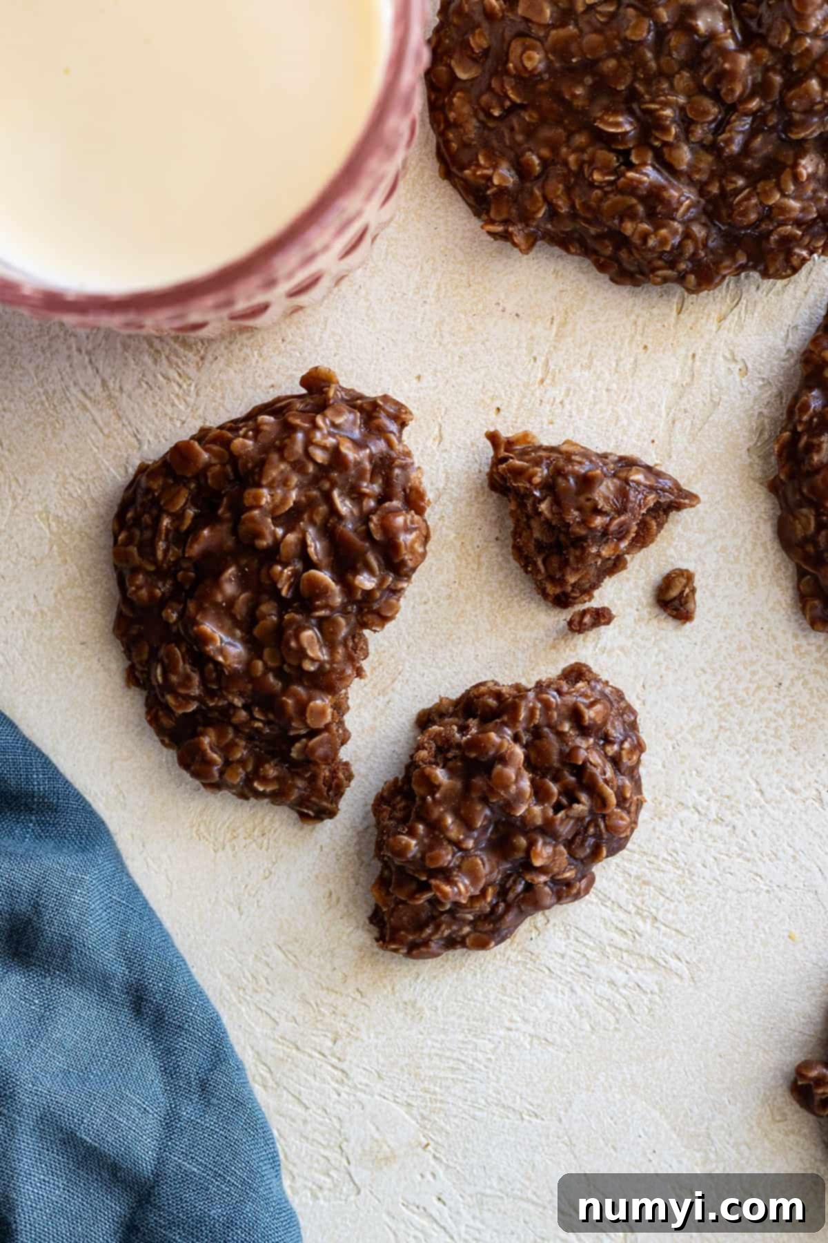 Peanut Butter Chocolate No-Bake Bliss Bombs 6 Overhead view of a cookie broken into pieces with a glass of milk in the corner.