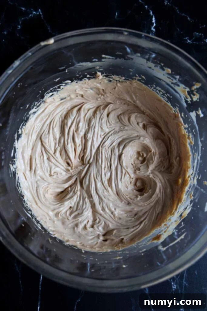 Grandma's Peanut Butter Cookies 5 Shortening, butter, and peanut butter creamed together in a glass bowl.