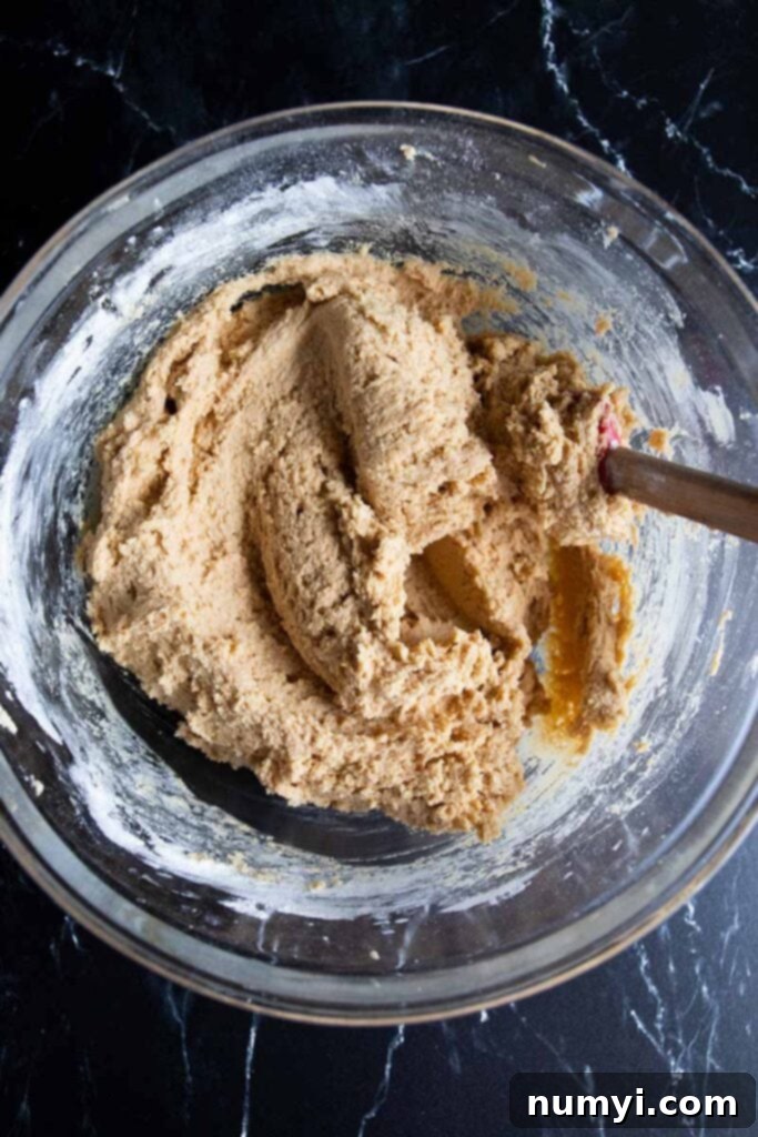 Grandma's Peanut Butter Cookies 6 Peanut butter cookie dough in a glass mixing bowl.