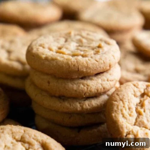 Grandma's Peanut Butter Cookies 9 Peanut butter cookies on a wire rack in a baking sheet.