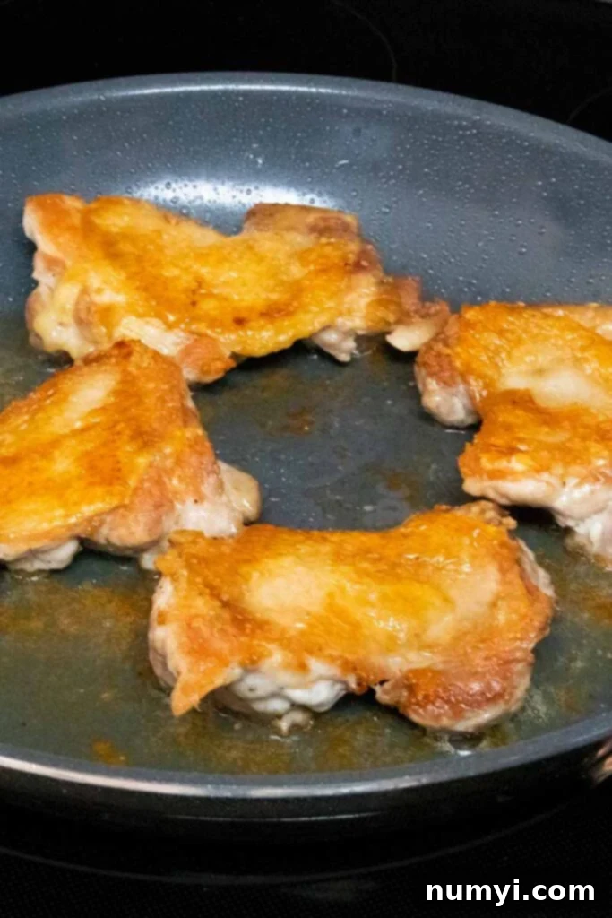 Mouthwatering Golden Crispy Teriyaki Thighs 6 Crispy chicken thighs cooked, in a skillet