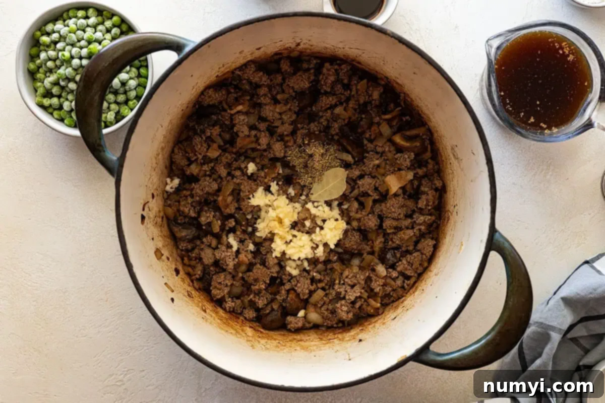 Adding in the aromatics to the browned meat and vegetables. 