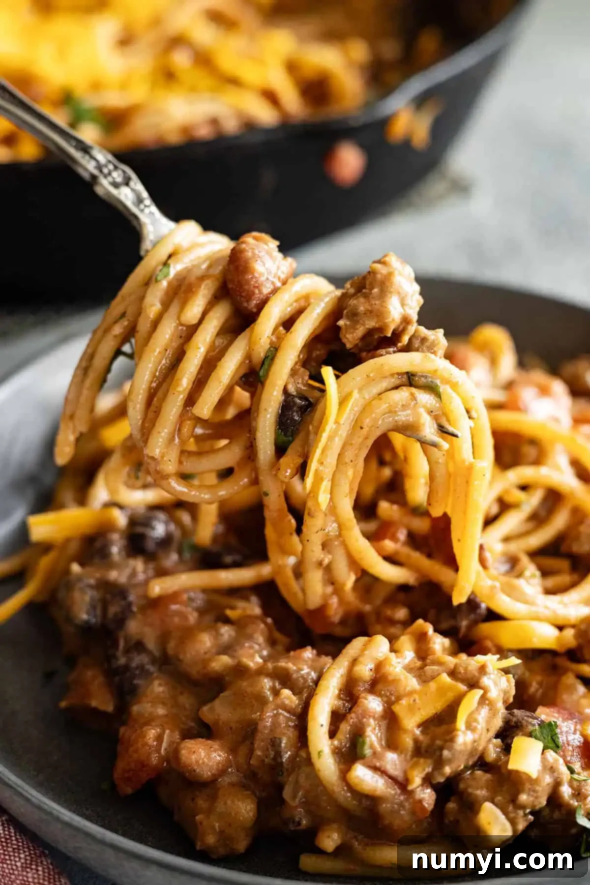 Fork twirling pasta.