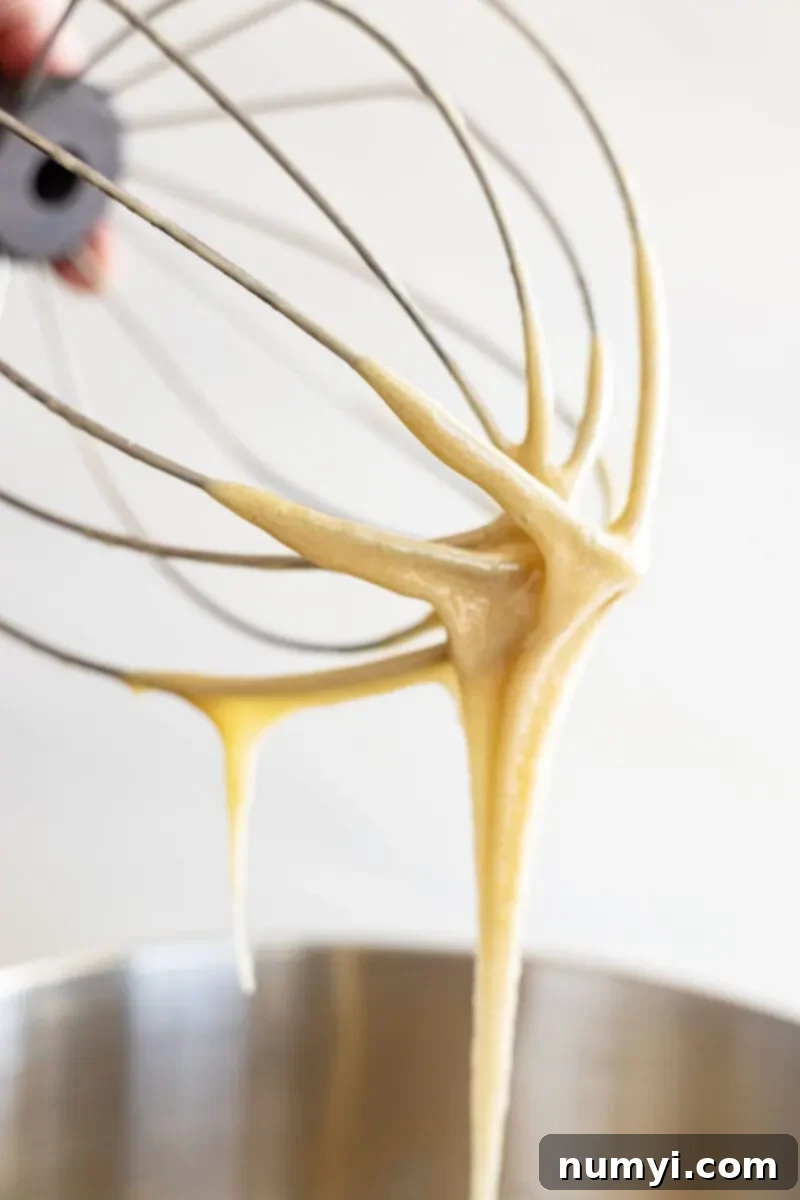 Whip Up Irresistibly Creamy Honey 4 Wire whip pulling up honey and letting it drizzle down.