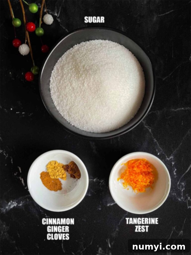 Craft Your Own Holiday Spice Flat White 3 Various ingredients for the holiday spice flat white laid out on a dark background, showcasing spices, tangerine, and coffee beans.