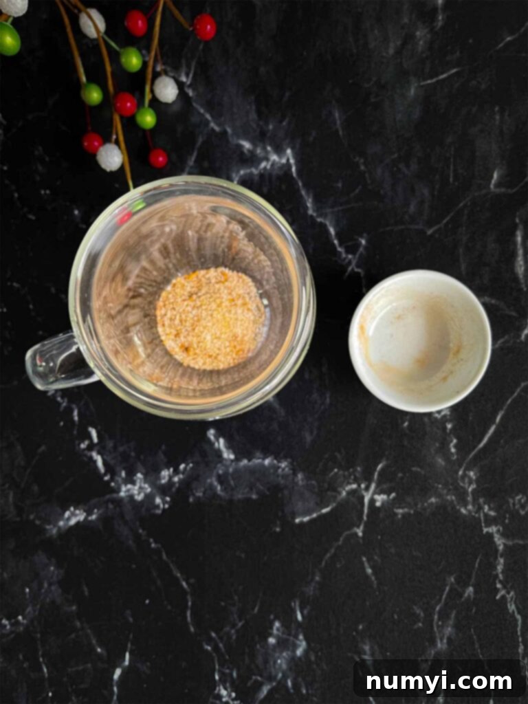 Craft Your Own Holiday Spice Flat White 5 Holiday spice flat white spice mixture, including tangerine sugar, in the bottom of a clear glass coffee mug.