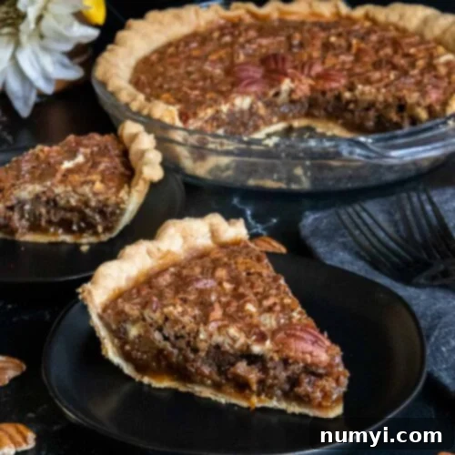 Slices of pecan pie on black plates.