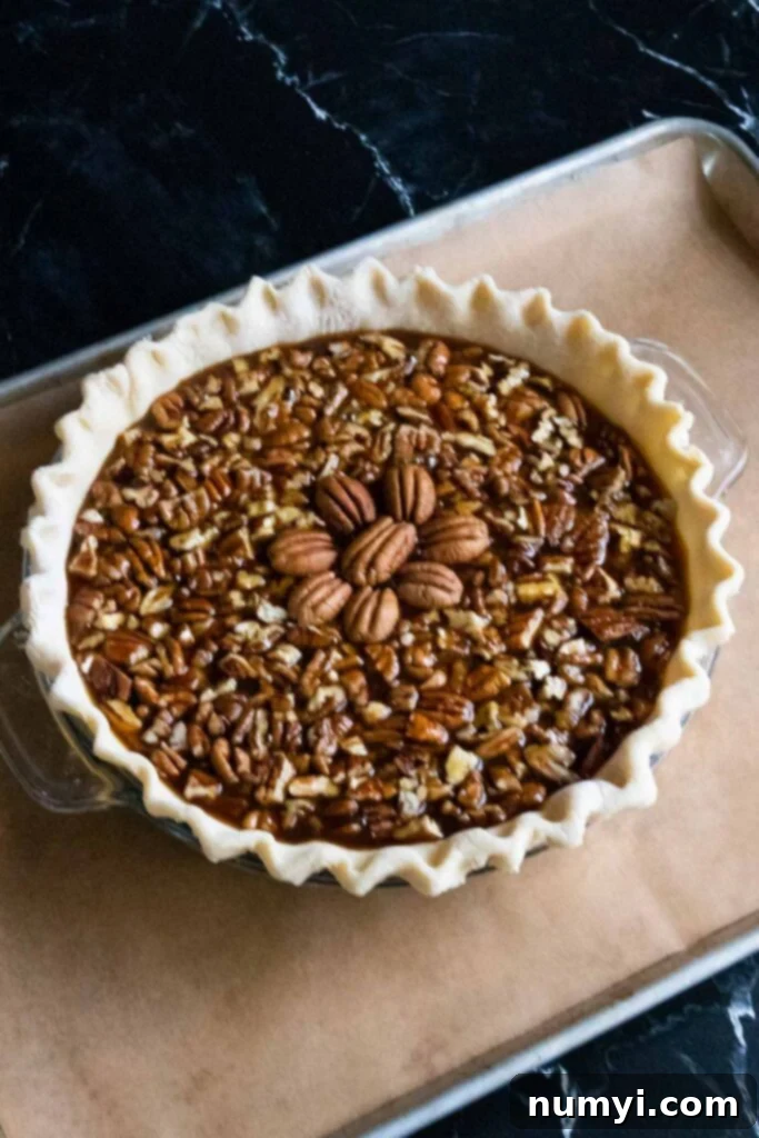 Unbaked pecan pie on a baking sheet.