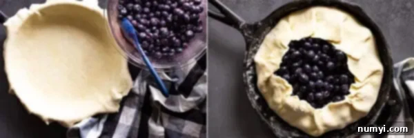 Overhead view of filling the pie crust and folding it over the blueberries.