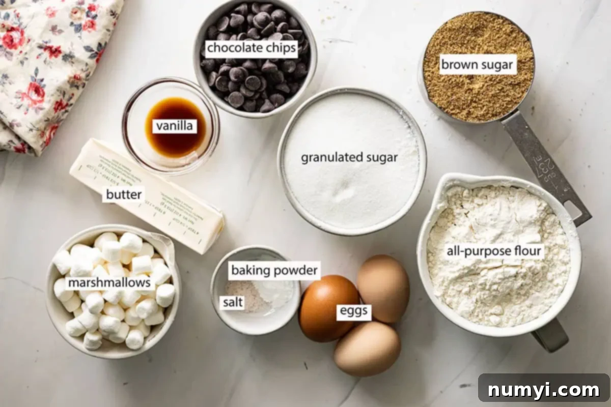 Ingredients for Mud Hen Bars: butter, vanilla, eggs, marshmallows, salt, baking powder, chocolate chips, granulated sugar, brown sugar, and all-purpose flour arranged on a counter.