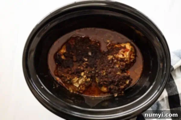 Picture of chicken finished cooking in slow cooker.