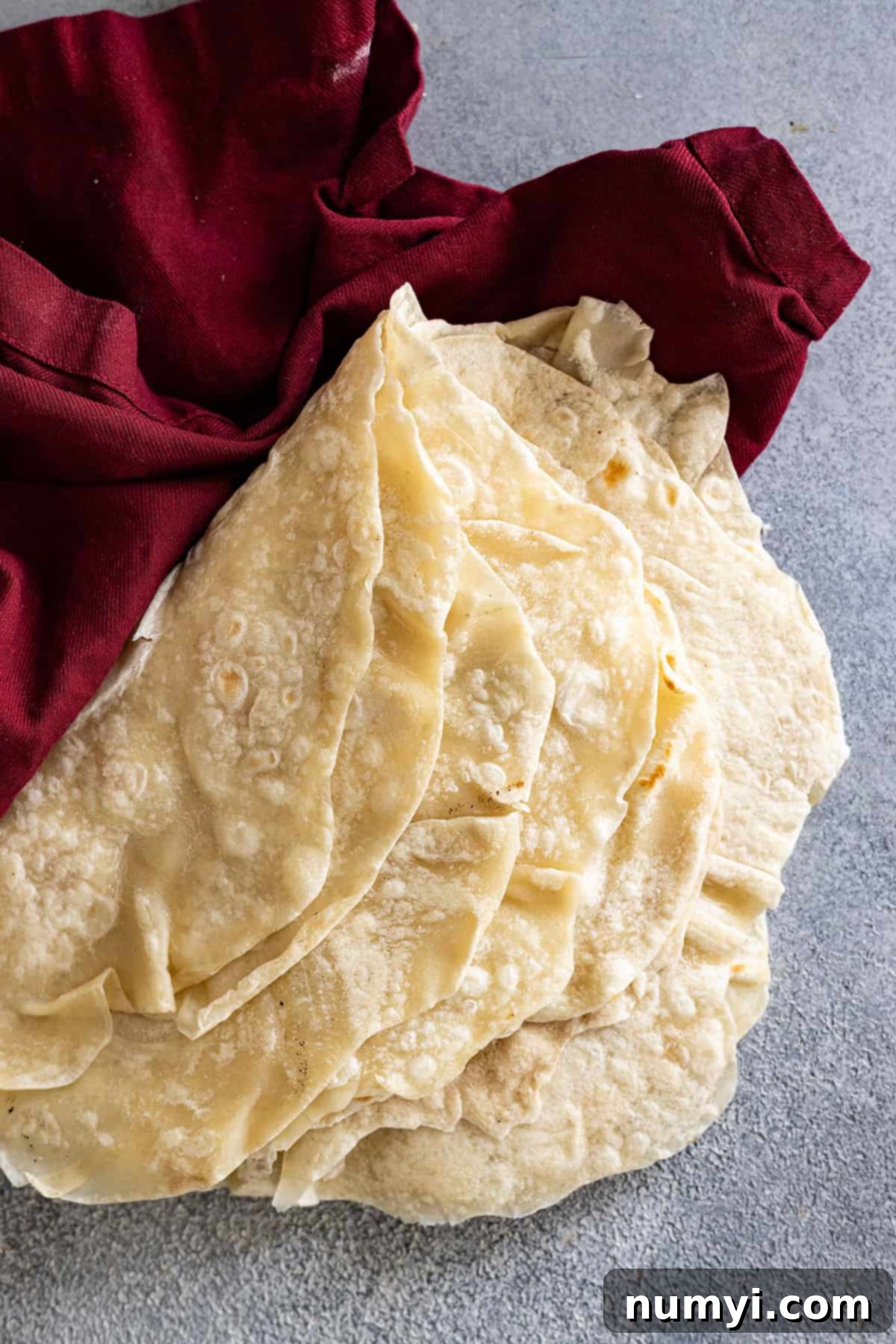 Easy Homemade Flour Tortillas 7 Several tortillas stacked up and folded over.