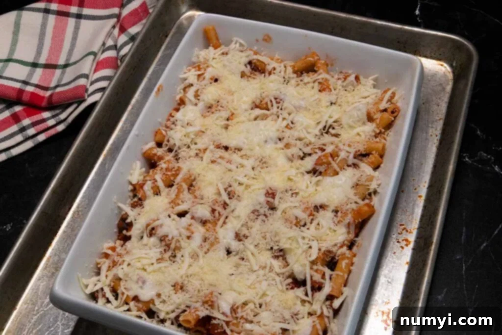 an assembled ziti casserole dish ready to go into the oven