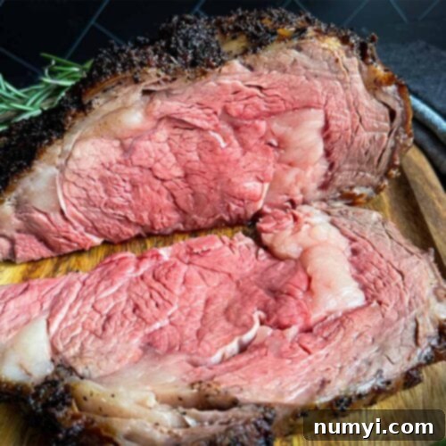 Closed Oven Prime Rib Roast 10 A round thumbnail image of a sliced prime rib roast garnished with rosemary.