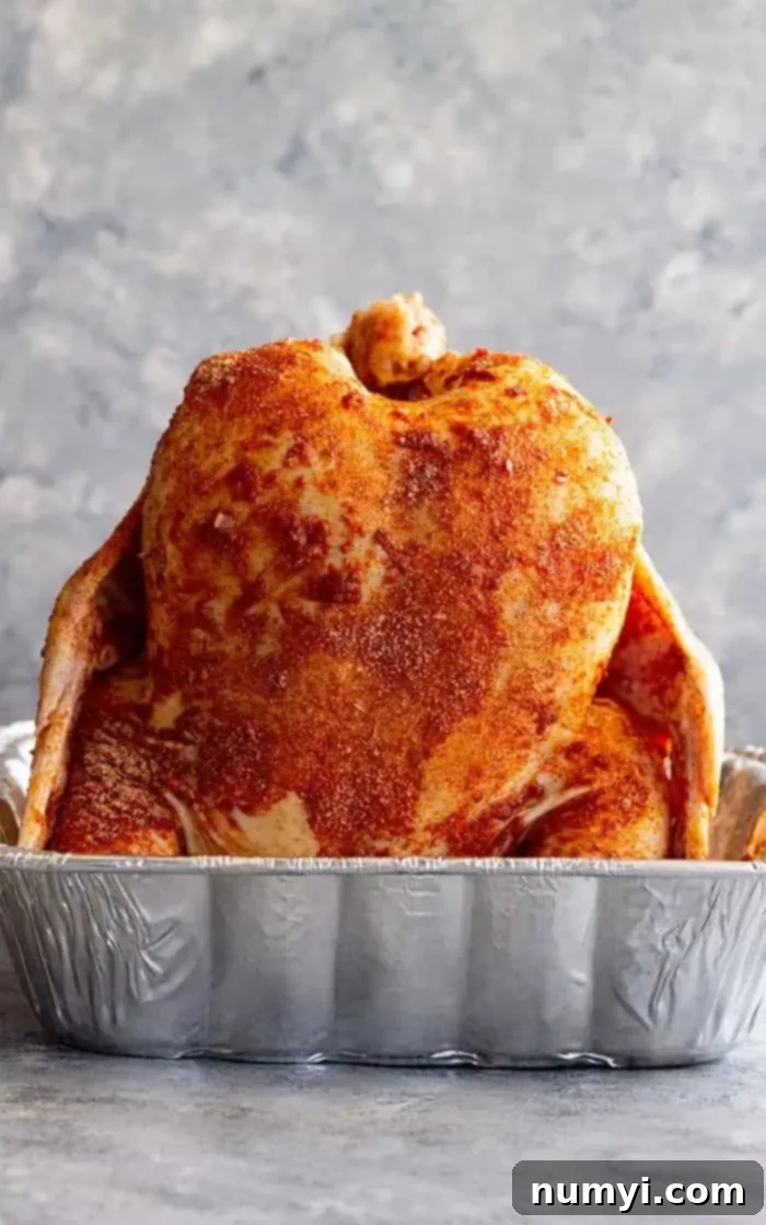 Moist Beer-Steamed Chicken 4 side view: getting beer can chicken in oven ready to bake with rub