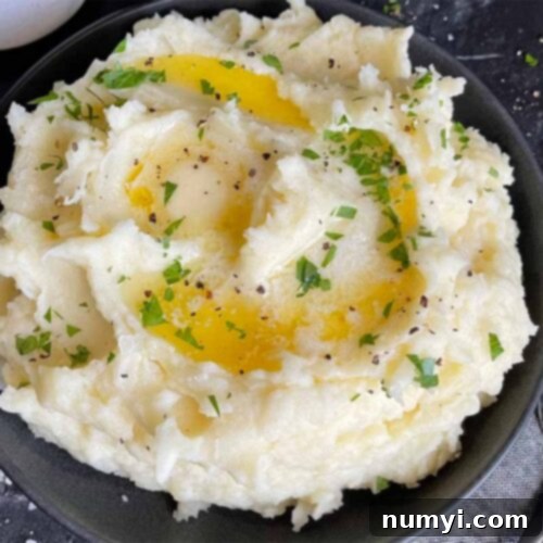 Mashed potatoes with butter in a dark bowl