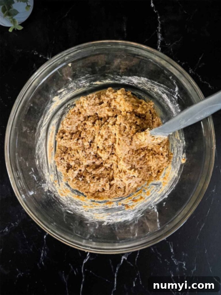Salty Sweet Peanut Butter Pretzel Bars 6 Peanut butter pretzel bar mixture in a glass mixing bowl, ready to be pressed.