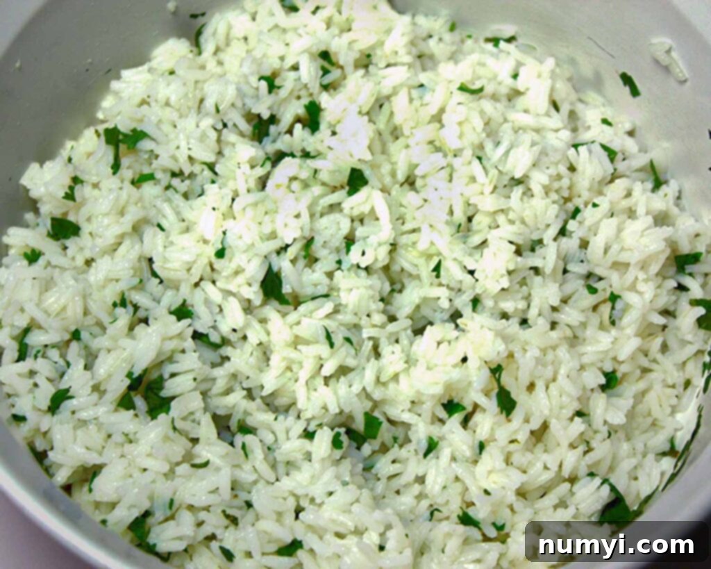 Vegetarian Burrito - An easy, meatless meal option! Fresh, tangy and absolutely delicious! Bright green cilantro-lime rice is served in a clean white bowl, highlighting its fresh, zesty preparation, perfect for a delicious burrito filling.