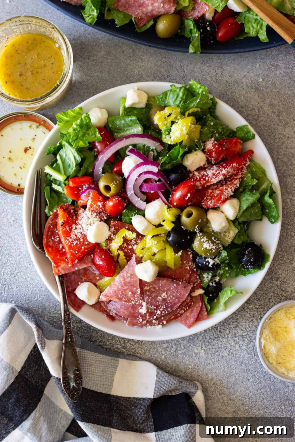 Big Italian Deli Salad 6 Overhead view of a beautiful single serving of Antipasto Salad on a clean white plate, showcasing the vibrant colors and fresh ingredients.