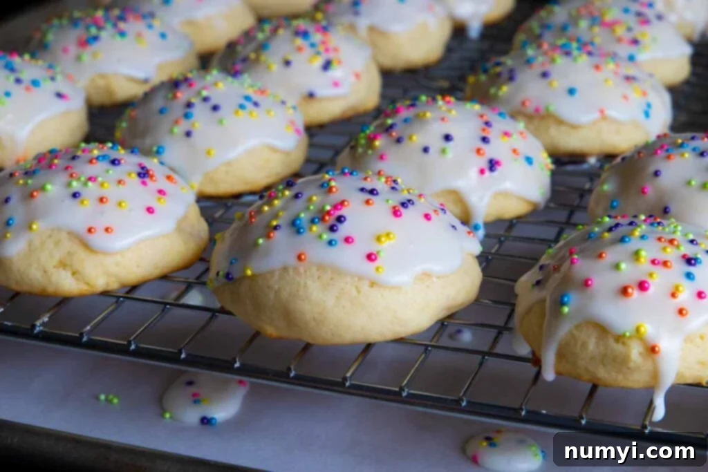Italian ricotta cookies with glaze drying on a wire rack, freshly made and sprinkled