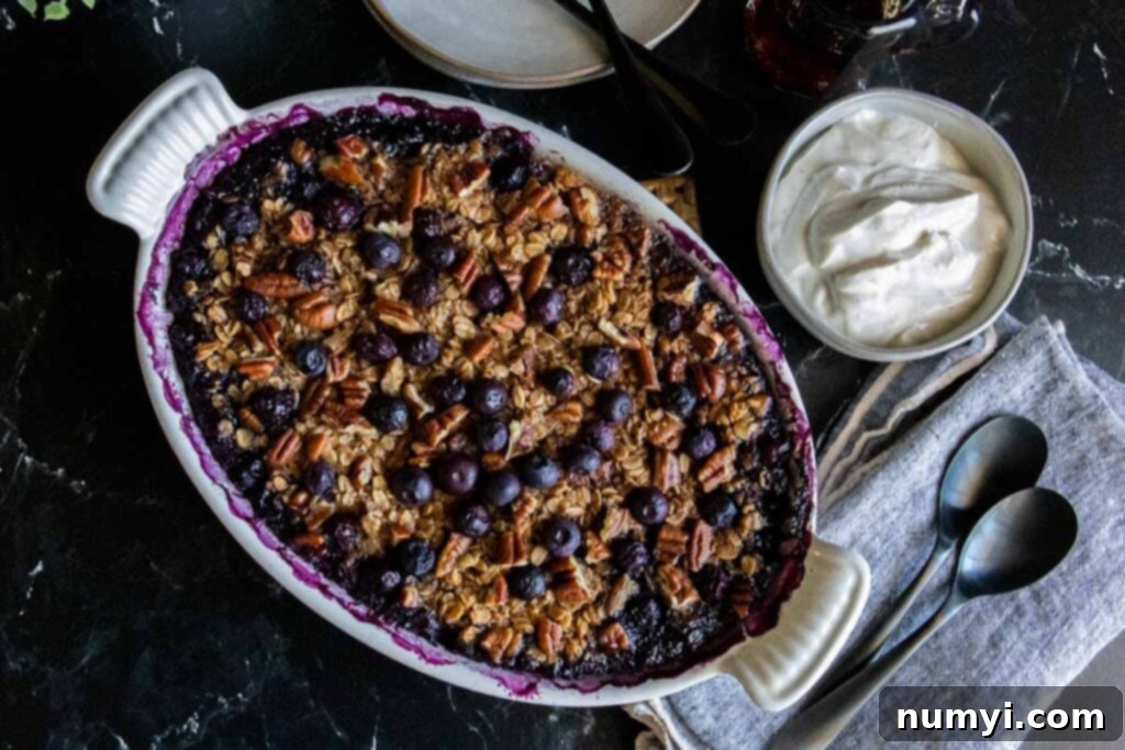 Blueberry baked oatmeal in a white oval baking dish.
