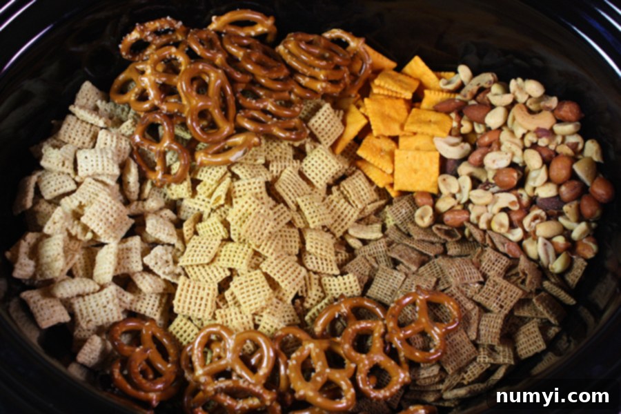 Chex Mix ingredients in the crock of the slow cooker.