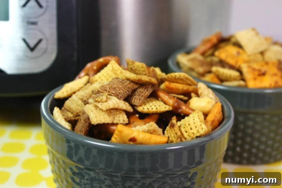 Slow Cooker Chex Mix in a blue serving bowl.