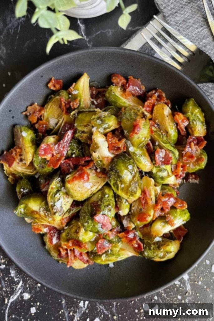 A bowl of freshly prepared Roasted brussels sprouts with honey butter and bacon.