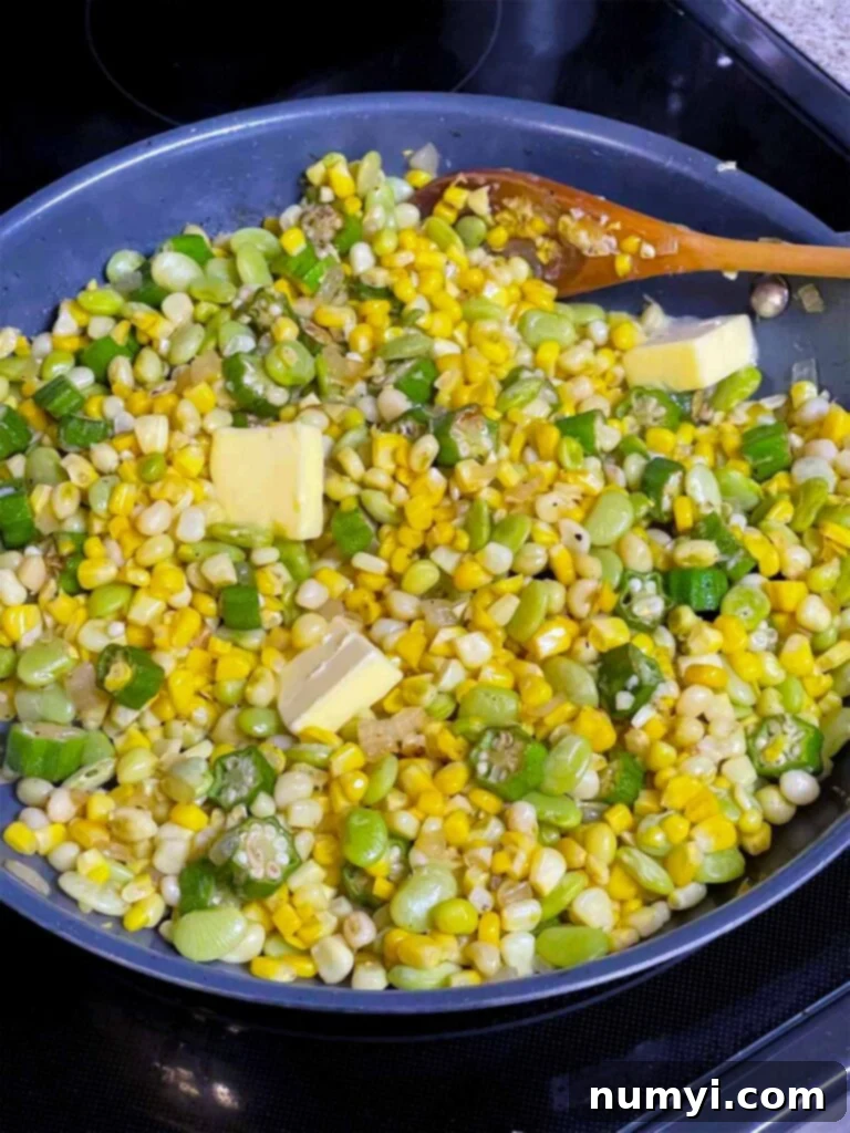 Fresh corn, cooked lima beans, and zipper peas being added to the sautéed okra and onions in a skillet, ready for the butter and seasonings.