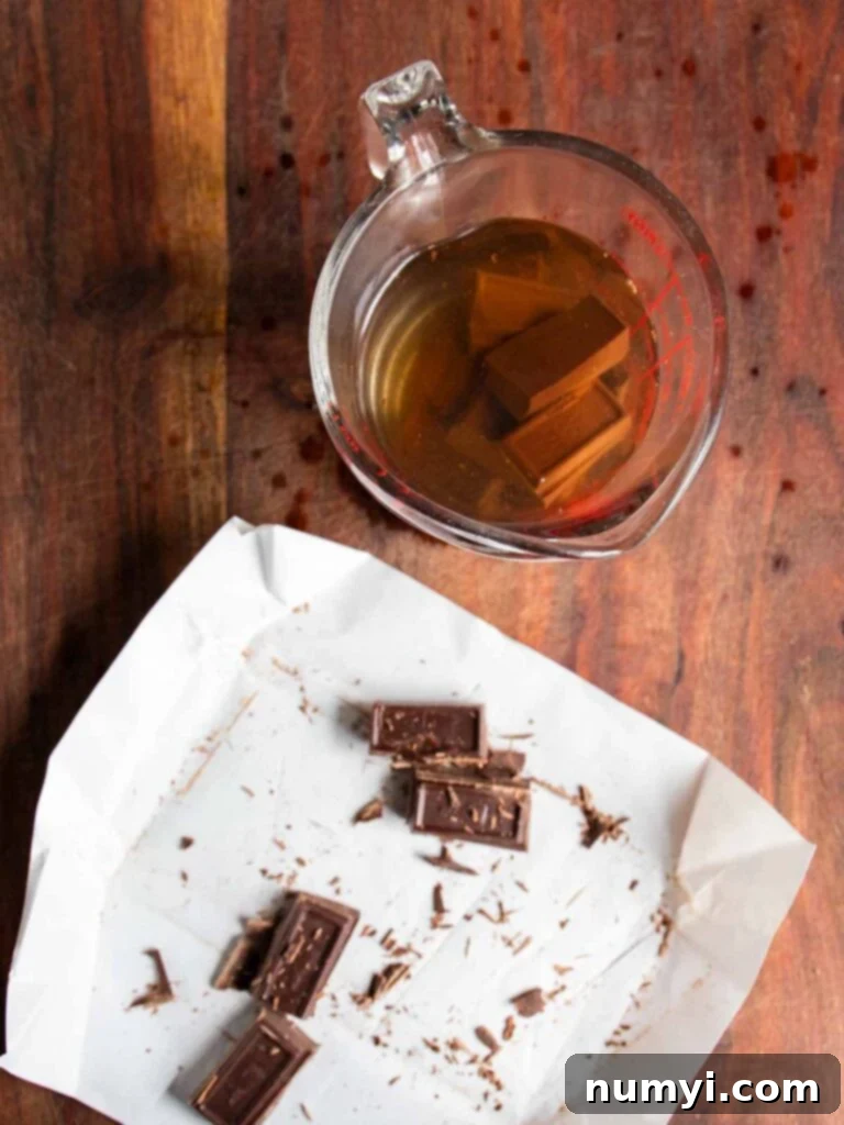 Baker's German Sweet Baking Chocolate squares melting in a glass measuring cup with boiling water, creating a smooth chocolate mixture.